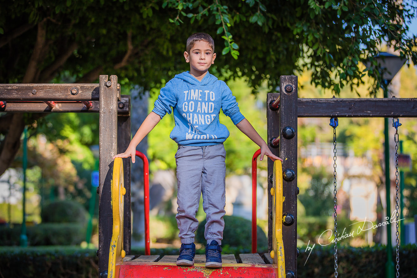 Handsome young boy in the park's playground, moments captured by Cristian Dascalu during a beautiful Limassol family photography photo session.
