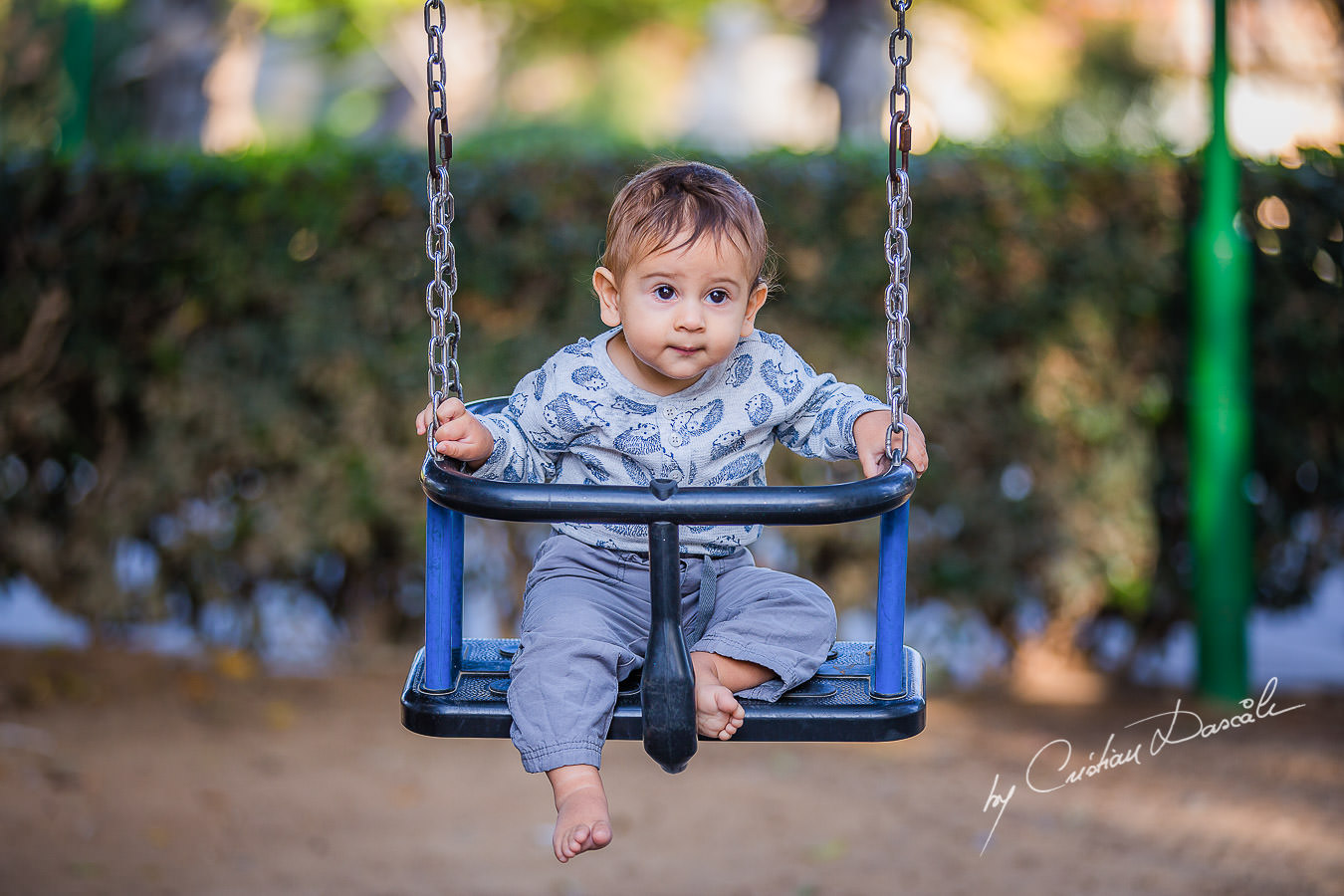 Smallest family member in swing, moments captured by Cristian Dascalu during a beautiful Limassol family photography photo session.