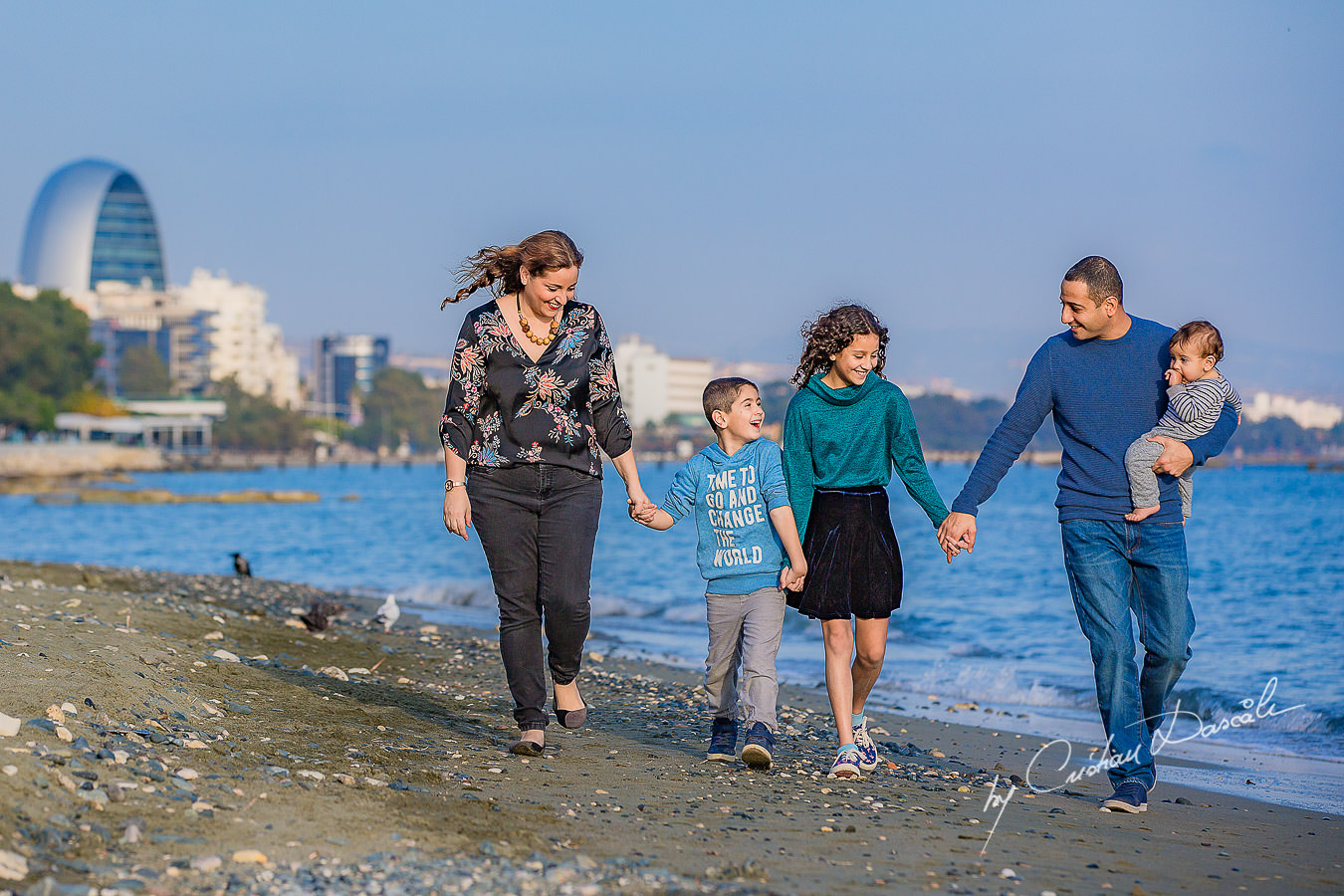 Family walking on a beach, moments captured by Cristian Dascalu during a beautiful Limassol family photography photo session.