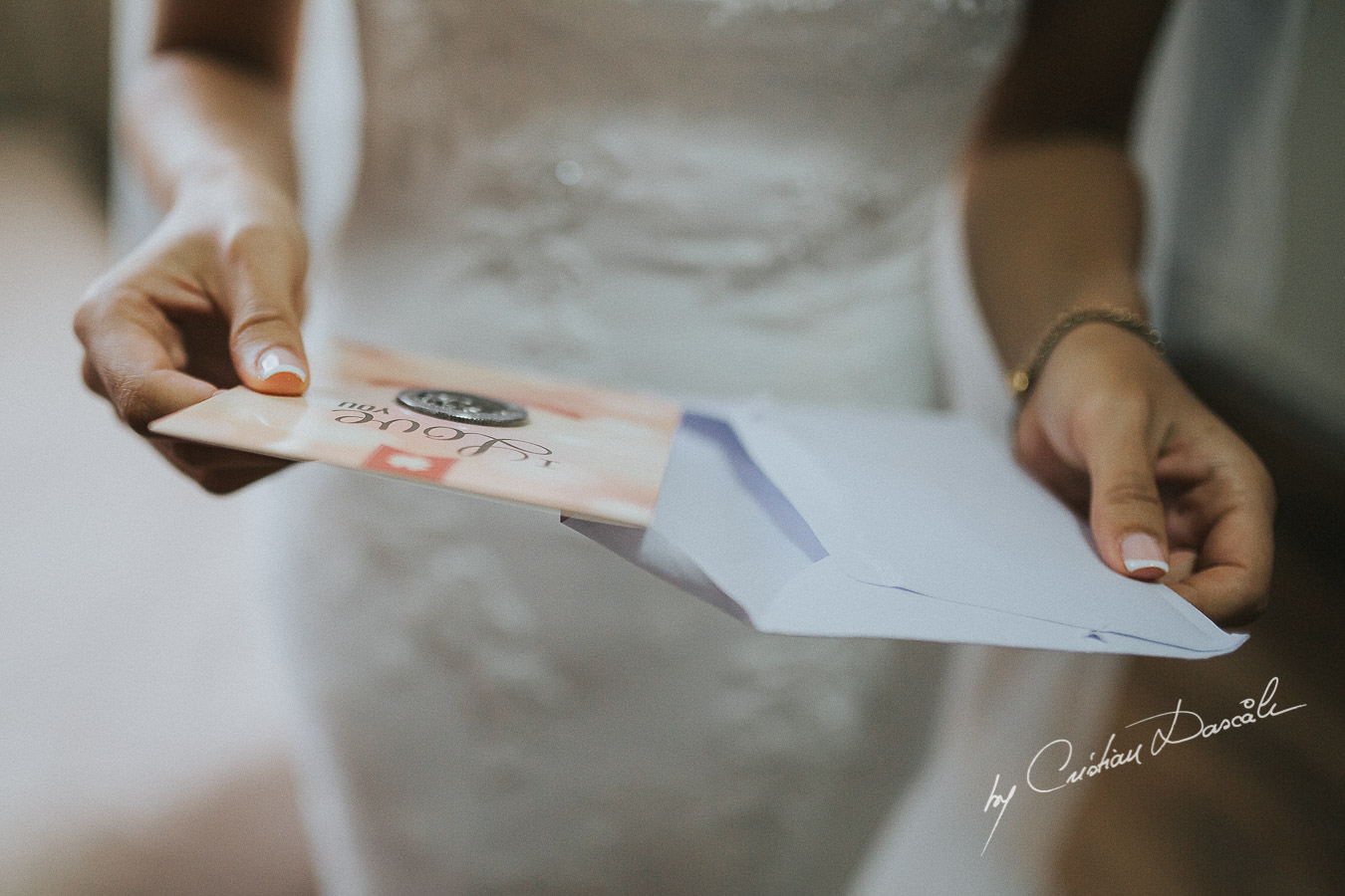 The bride Christina, opening a gift form her future husband to be, moments captured during a wedding at St Raphael Resort in Limassol, Cyprus.