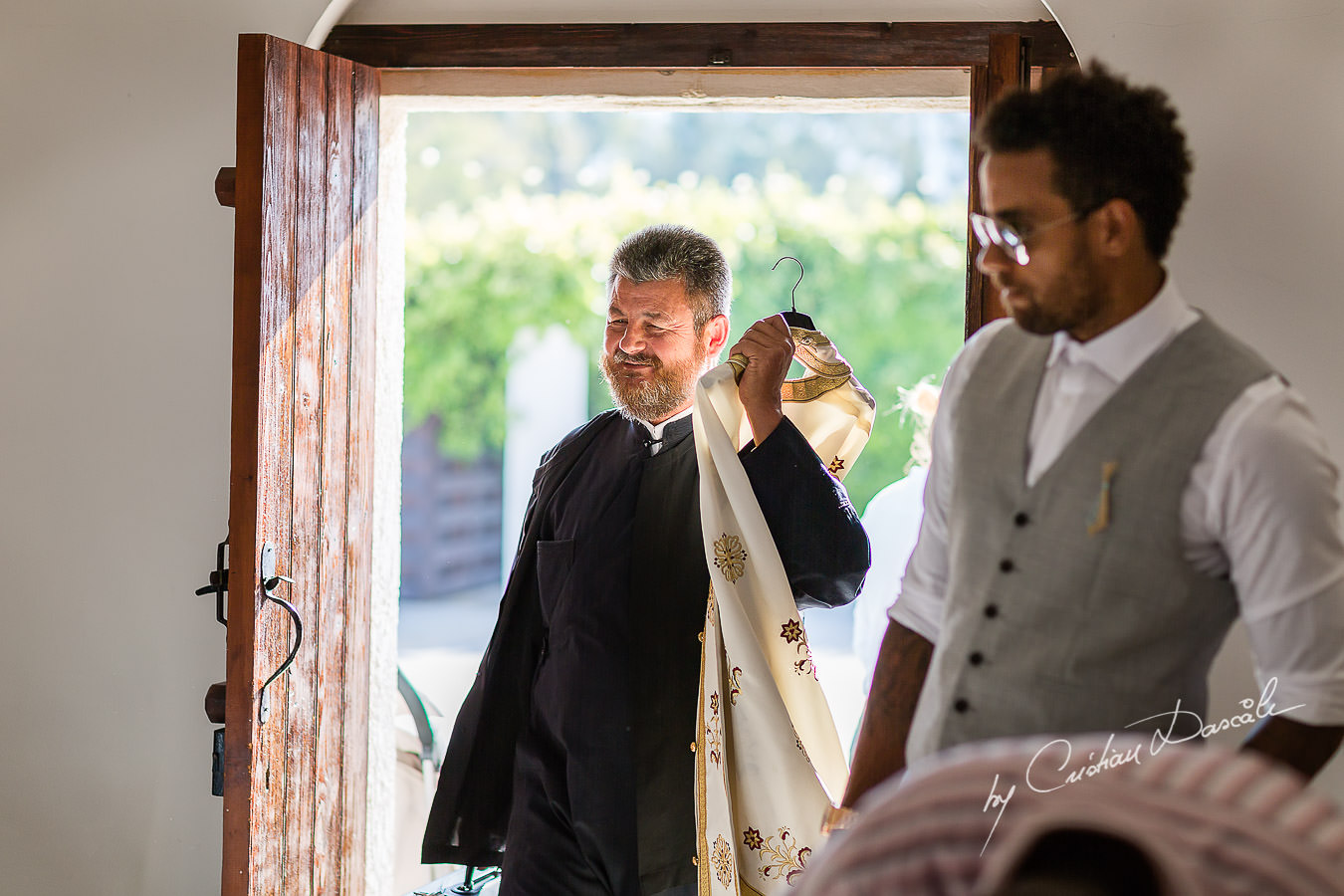 The priest arriving for a Christening the beautiful Anassa Hotel photographed by Cyprus Photographer Cristian Dascalu.