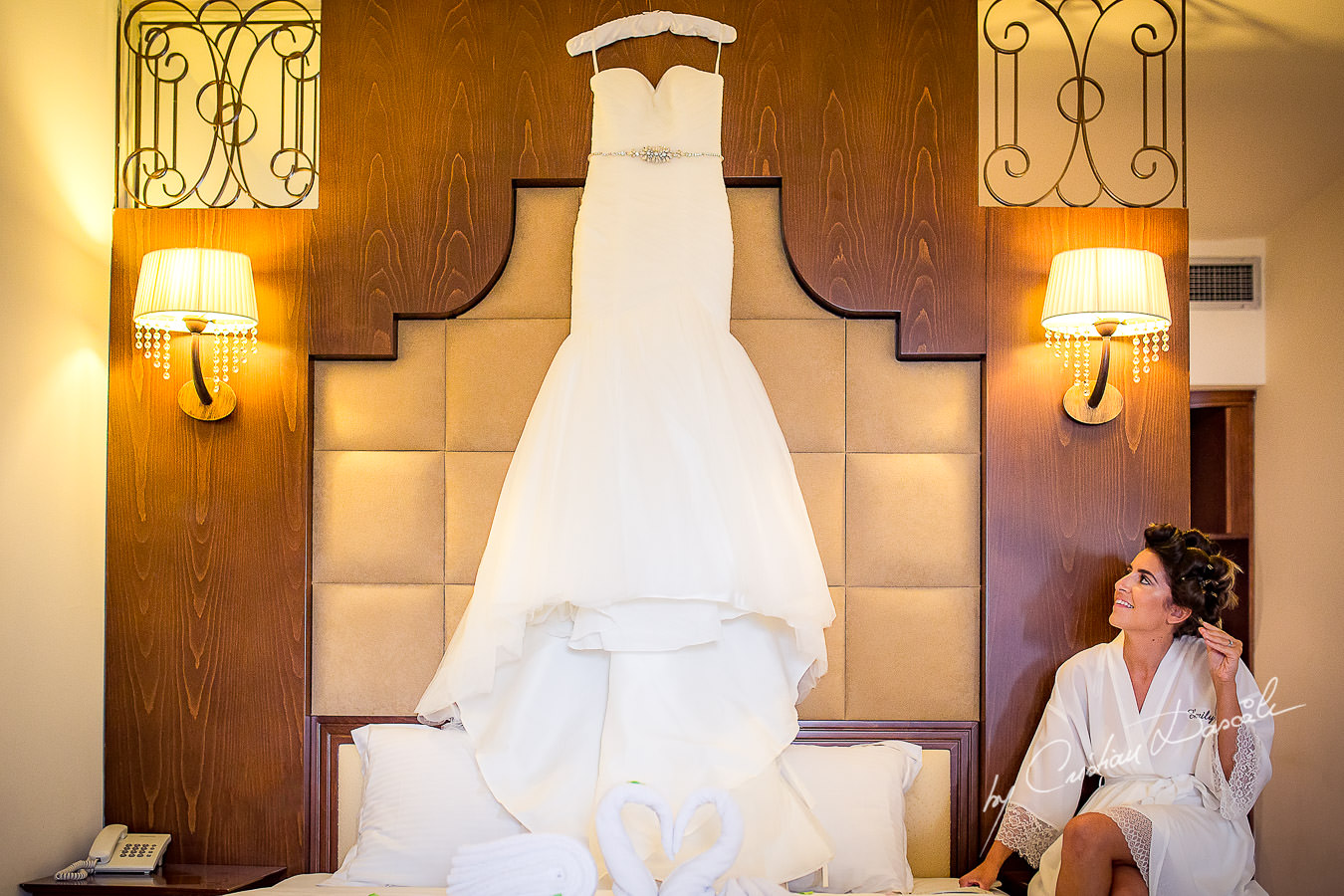 Bride admiring her Wedding Dress at a Beautiful Wedding at Elias Beach Hotel captured by Cyprus Photographer Cristian Dascalu.