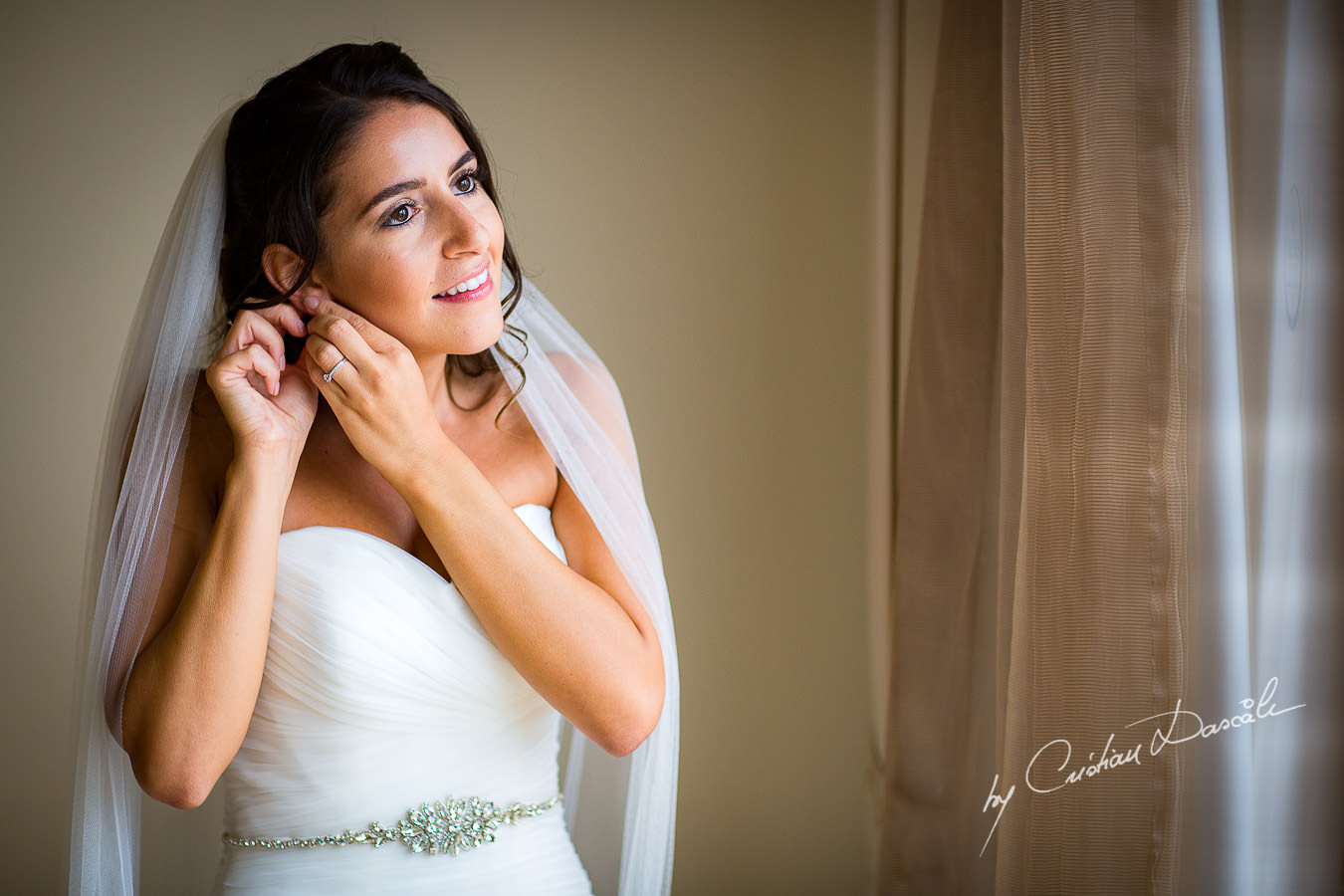 The bride getting ready during a Beautiful Wedding at Elias Beach Hotel captured by Cyprus Photographer Cristian Dascalu.