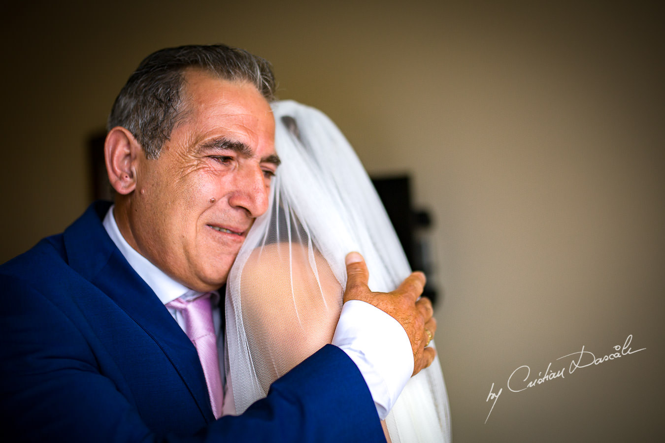 The father of the bride seeing his daughter for the first time during a Beautiful Wedding at Elias Beach Hotel captured by Cyprus Photographer Cristian Dascalu.