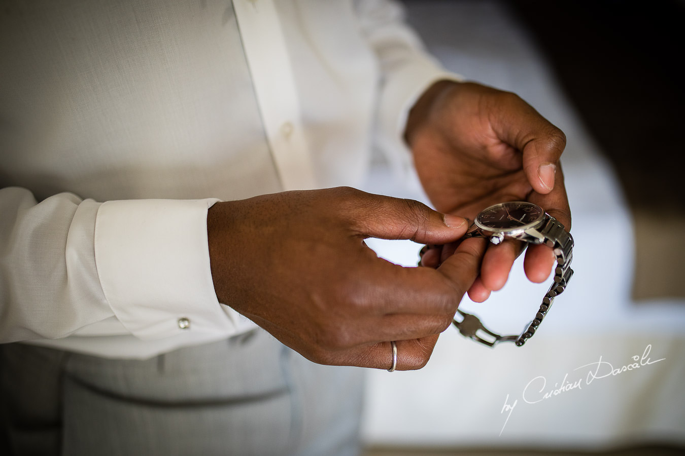 Groom setting his watch, moments captured during an Exquisite Wedding at Asterias Beach Hotel by Cyprus Photographer Cristian Dascalu.