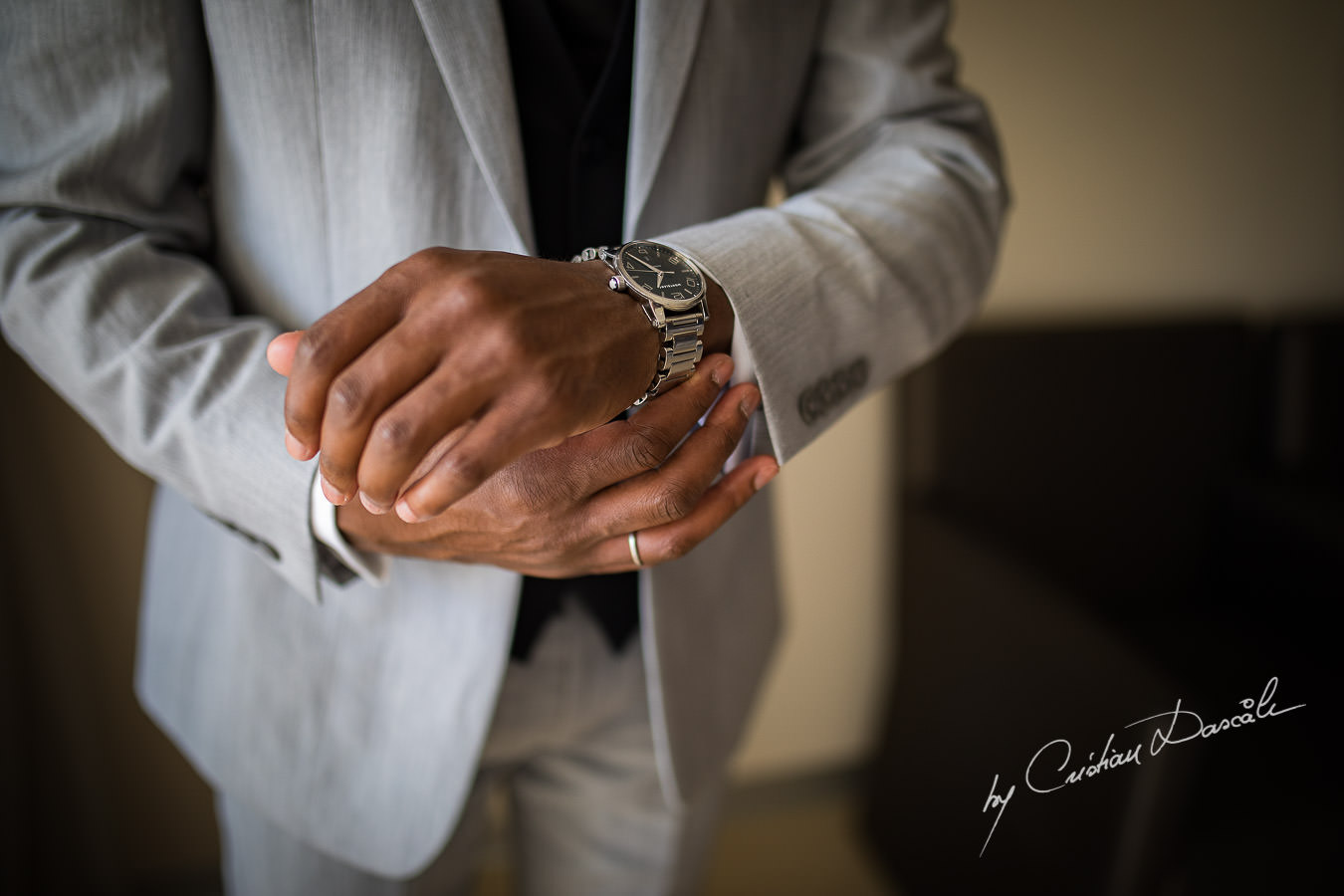 Groom closing his watch captured during an Exquisite Wedding at Asterias Beach Hotel by Cyprus Photographer Cristian Dascalu.