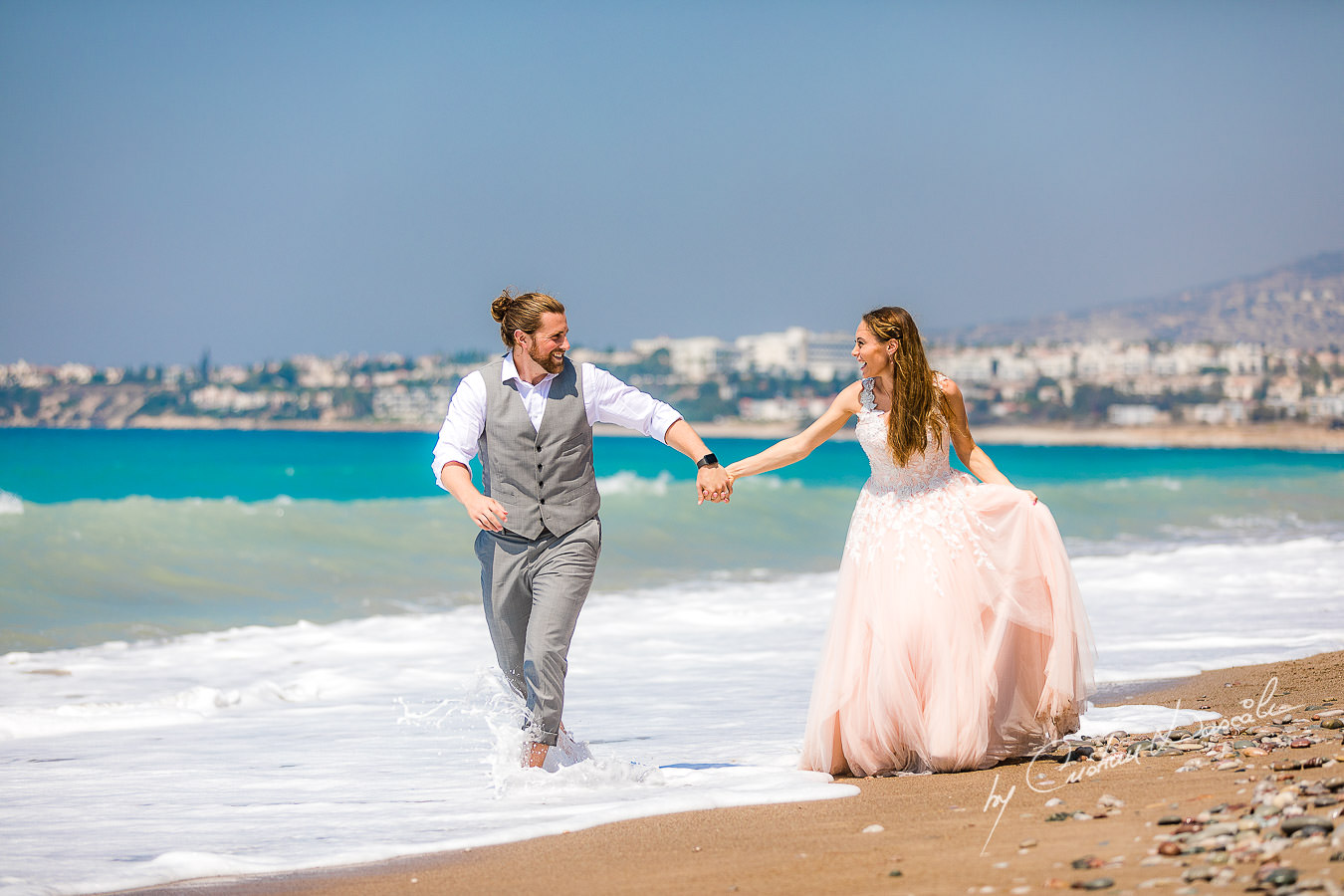 Bride and groom running naturally on the beach, moments captured at a Shamanic Wedding Ceremony by Cyprus Wedding Photographer Cristian Dascalu.