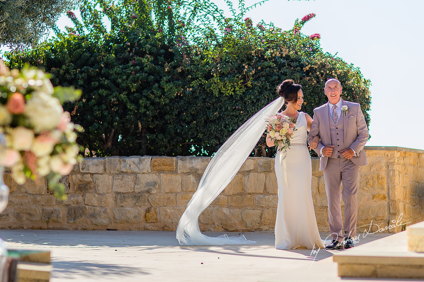 The bride arrives with her father, moments captured by Cristian Dascalu during an elegant Aphrodite Hills Wedding in Cyprus.