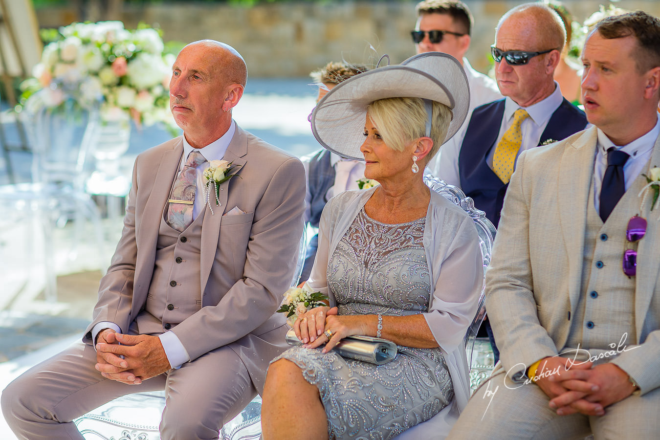 Bride`s parents looking at the couple, moments captured by Cristian Dascalu during an elegant Aphrodite Hills Wedding in Cyprus.