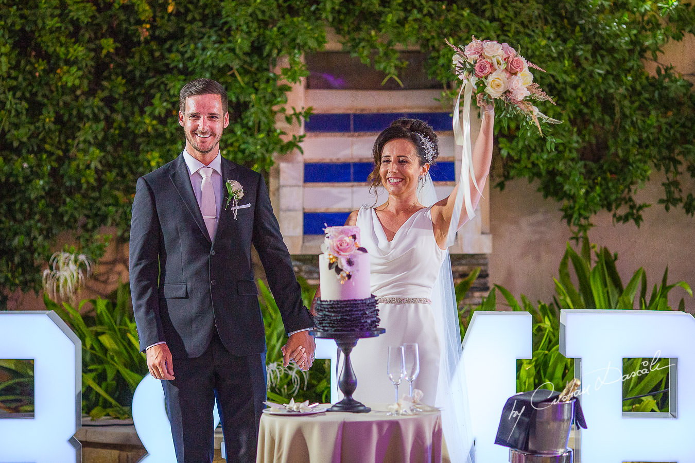 Cutting the cake moments captured by Cristian Dascalu during an elegant Aphrodite Hills Wedding in Cyprus.