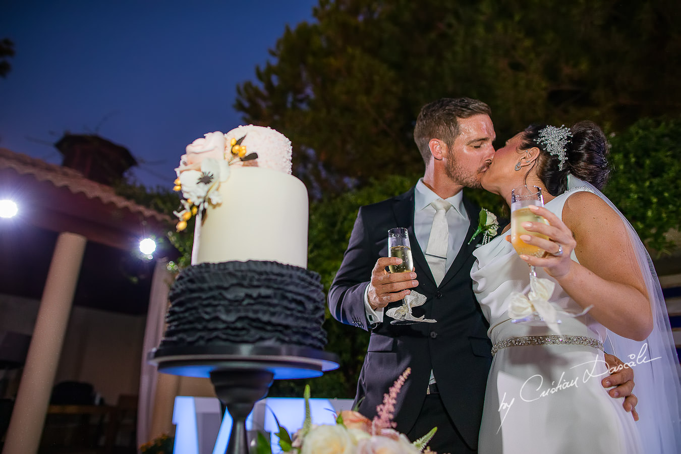 Cutting the cake moments captured by Cristian Dascalu during an elegant Aphrodite Hills Wedding in Cyprus.